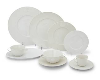 176 A KPM porcelain 'Arcadia' dinner service Late 20th century Designed 1938 by Trude Petri (1906-1986) Comprising: 13 chargers (11 3/8 in.) 8 dinner plates (10 1/4 in.) 26 salad plates (8 in.) 12 bread & butter plates (6 1/4 in.) 16 cream soup bowls (height 2 1/4 in.) 9 flat cups (height 2 1/4 in.) 12 saucers (6 5/8 in.) 4 demitasse cups (height 2 1/8 in.) 5 demitasse saucers (5 1/4 in.) 3 sugar plateaus (width 9 1/2 in., depth 6 3/4 in.) Each with KPM underglaze scepter 108 pieces Estimate: $1,500 - $2,500
