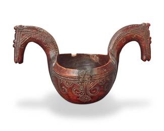 93 A Norwegian carved wood ale bowl Late 18th century With double horse-head handles Height 4 3/4 in., width 8 1/2 in., depth 5 in. Estimate: $400 - $600
