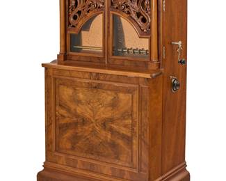 267 A Regina Corona music box, model 33 Circa 1897 The auto-changer music box, playing twelve 27 in. discs with dual combs, spring barrels, barley twist pressure bar, and star flywheel, housed in a birch wood upright case with two upper hinged doors with openwork dragon frets flanked by Corinthian columns, with verso sound board, raised on casters Serial number: 47502; signed to gilt-iron bedplate: REGINA Height 66 1/4 in., width 37 1/2 in., depth 24 1/4 in. Estimate: $4,000 - $6,000