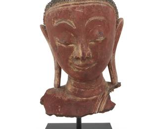 367 A Southeast Asian lacquered papier-mâché head Rattanakosin period (1782-1932) or earlier, Burmo-Thai Mounted on a custom painted wood stand Height of head 16 in., width 10 in., depth 9 in.; height overall 20 1/2 in. Estimate: $500 - $700