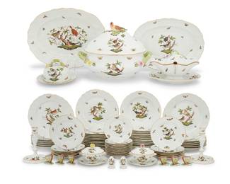 4 A Herend porcelain ‘Rothschild Bird’ dinner service 20th century Comprising: 12 service plates, 1527 (10 3/4 in.) 12 dinner plates, 1522 (10 1/4 in.) 12 salad plates, 1518 (7 1/2 in.) 12 bread plates, 1515 (6 1/4 in.) 12 soup bowls, 1501 (9 1/2 in.) 12 covered cream soup bowls and underplates, 740 (width across handles 4 3/4 in.) 1 covered tureen with bird finial, 1005 (height 11 in., width across handles 14 1/2 in.) 1 sauce boat with fixed underplate, 238 (height 6 1/4 in., width 9 3/4 in.) 2 graduated platters, 1102, 1101 (14 3/4 in. and 16 3/4 in.) 2 covered butter dishes, one with lemon finial, one with branch handle, 1380 (height of taller 4 3/4 in., diameter 7 1/2 in.) 1 pair of candlesticks, 7916 (7 in.) 2 pairs of salt & pepper shakers, 250 and 260 Together with 12 associated Herend butterfly-form place card holders, 5350 Various blue printed factory marks, above shape numbers and pattern code RO, some impressed ‘HEREND’ and shape numbers 108 pieces $8,000-12,000