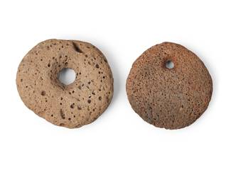 197 Two Hawaiian stone perforated sinkers Hawaiian Islands 2 pieces Diameters 4 1/2 in. and 4 3/4 in. Estimate: $800 - $1,200