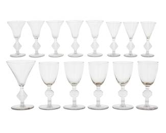 379 A group of fourteen Rene Lalique glass goblets Second quarter 20th century Each pattern originally designed 1924 Comprising five 'Barr' cordials and eight 'Saverne' wine glasses and one champagne Ten etched: R Lalique / France; and numbered '5009' or '5070' or '5071'; four cordials with stencil mark: R LALIQUE / FRANCE 14 pieces Height of tallest 5 1/4 in., height of shortest 4 7/8 in. Estimate: $800 - $1,200