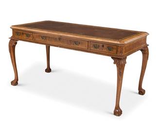 318 A Burton-Ching George III style burl walnut partner's desk Circa 2000 With inset blind and gilt-stamped leather top above three locking drawers to each side, the centers with fitted interior and pen rest, raised on ball-and-claw feet Marked to lock: Burton-Ching Height 30 1/4 in., width 60 1/2 in., depth 30 1/4 in. Estimate: $700 - $900