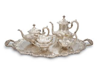 24 A Reed & Barton sterling silver 'Burgundy' coffee & tea service Second half 20th century Comprising: Coffee pot (height 9 3/4 in., width 10 1/2 in., depth 5 1/4 in.) Teapot (height 7 in., width 11 in., depth 5 in.) Covered sugar bowl (height 6 in., width 8 1/8 in., depth 4 3/8 in.) Creamer (height 5 1/4 in., width 6 in., depth 3 5/8 in.) Each with factory marks for sterling and: 745 Burgundy Together with a silver plated tray (width 29 in., depth 19 3/4 in.) 5 pieces Total weight 256.6 gross oz. troy approximately Estimate: $1,800 - $2,200