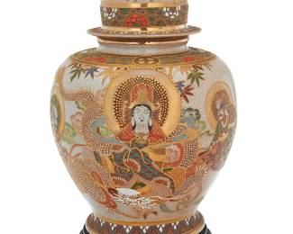 218 A large Japanese Satsuma moriage glazed ceramic lidded jar 20th century Raised on a wood base Bearing mark reading 'Seizan' Height of jar 22 1/4 in., diameter 14 in; height mounted on base 24 in. Estimate: $800 - $1,200