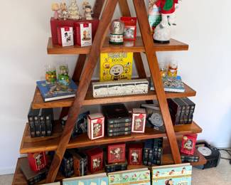 Charles Schulz Peanuts books, ornaments, and memorabilia and mcm style A shaped mango wood shelf