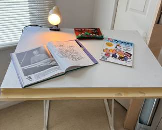 Charles Schulz Peanuts books on adjustable drafting/art table
