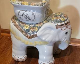 An elephant to hold a plant, oranges, or your little dog.  The possibilities are endless.  He sits in the hallway beyond the kitchen, eagerly awaiting your attention.  I hope you know sign language because I don't think he can hear.  Also, I am about 80% sure this elephant is a him, but what do I know??