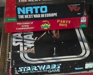 These vintage games are located under the mantle in the room in which you enter the house. 