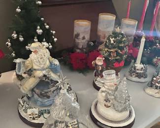 A few of the Thomas Kinkade/Bradford Exchange Light/Sound/Motion Trees, Figures and Candles