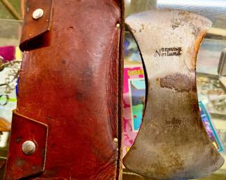 Genuine Norlund "Trail Blazer" double-bit cruiser axe head alongside its original embossed leather mask (sheath).
