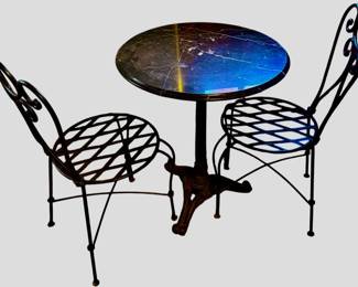 3-piece French-style bistro set features an elegant combination of a polished dark marble top table and two coordinating wrought iron patio chairs