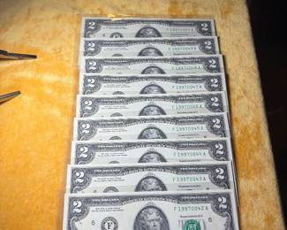 Two collections of consecutive two dollar bills