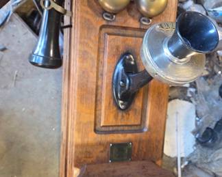 Several antique oak wall telephones