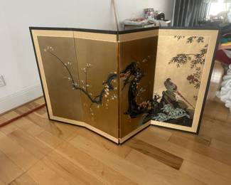 Japanese byobu (folding screen), typically a 4-panel tabletop or small room screen featuring a painted bird (such as a pheasant or duck) and flowering plum/cherry blossoms against a gold leaf or gold-toned background.