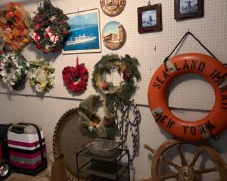 Wreaths, brass table, life ring