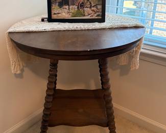 Wooden round accent table with bobbin-turned legs, and  glass ball-and-claw feet