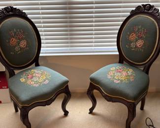     Pair of carved wooden accent chairs with floral needlepoint upholstery 