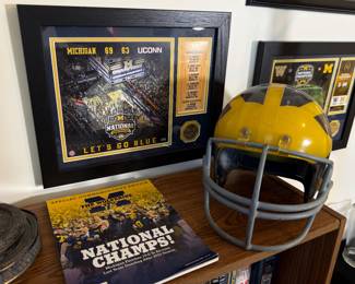 Vintage Marietta Kineomatic-21 football helmet with Michigan Wolverines winged design, gray face mask and visible wear. Made in USA