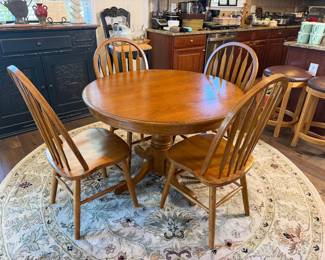     Round pedestal dining table with four spindle-back chairs