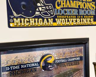     Michigan Wolverines 1997 national championship locker-room sign and framed football championship display.