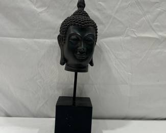 Buddha head statue on stand 