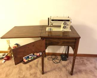 Sears Kenmore sewing machine with cabinet and accessories. Still works
