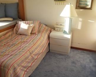 Twin bed; nightstand; table lamp