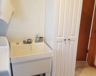 Laundry sink; tall white cupboard