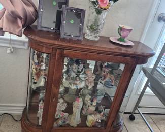 Beautiful  display cabinate with light. Contains vintage  and antique figurines made of porcelain 