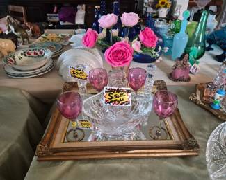 Vintage German crystal flower basket surrounded by  bohemian pink goblet and Crystal candle holders and other select items and mirror