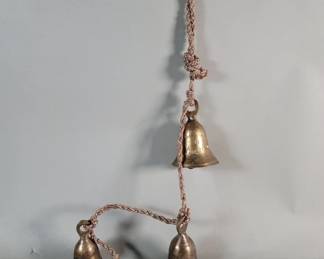 556 Lot 483 Vintage cluster of brass bells on a woven rope