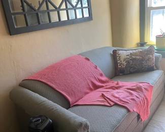Couch, personal heater and paned mirror