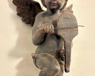 Vintage cherub figurine playing violin