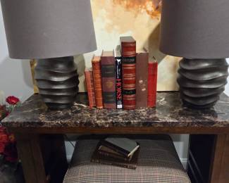 Pair of designer lamps, on sofa table with checked ottoman