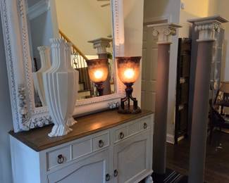 vintage credenza with huge vintage mirror, flanked by 2 vintage vases and carriage light