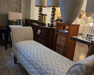 long lounging bench with decor and small tables or storage cabinets