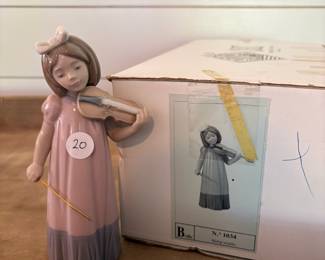 A21 - $10. Nao for Lladro. Nina Violin #1034. Violin Handle is broken.