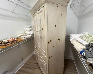 A49 - $100. Solid Wood Armoire with whitewash finish and floral design. Measures 43.75" x 22.25" x 76" tall. Doors slide into the cabinet.