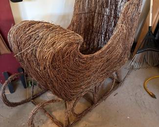 A66 - $125. Wicker Reindeer & Sleigh. Reindeer is 50" x 14" x 32" tall. Wicker Sleigh. Measures 47" x 20" x 33" tall.