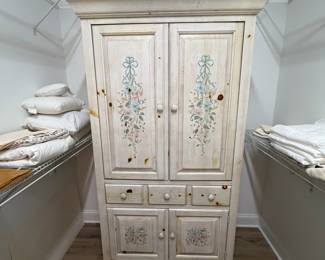 A49 - $100. Solid Wood Armoire with whitewash finish and floral design. Measures 43.75" x 22.25" x 76" tall. Doors slide into the cabinet.