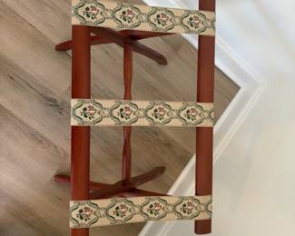 A26 - $40. Vintage Scheibe Wooden Folding Luggage Rack. Floral Tapestry Woven Straps. Measures 22.5" x 17" x 19.5" tall.