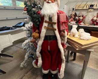 A68 - $75. Large Decorative Santa. Measures 60.5" tall. Has small hole in the top of his boot.