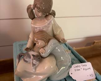 A20 - $20. Lladro "Little Sister" Figurine #1535. Measures 6.75" tall. *Missing a finger.* Includes original box.