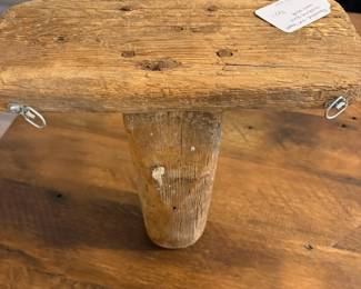 A60 - $50. Primitive One-Legged Milking Stool turned into a wall shelf. Measures 12" x 5.5" x 12" tall.