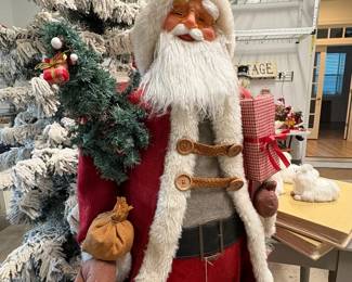 A68 - $75. Large Decorative Santa. Measures 60.5" tall. Has small hole in the top of his boot.