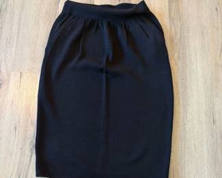 A96 - $45. Black St. John Knit Skirt. Size 6 Waistband elastic is bent.