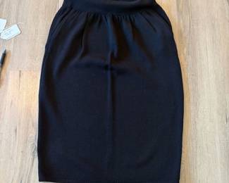 A96 - $45. Black St. John Knit Skirt. Size 6 Waistband elastic is bent.