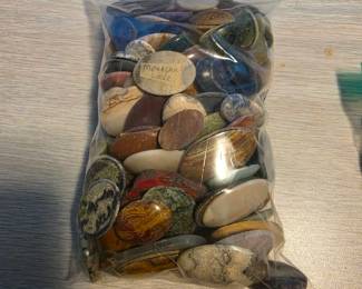 large collection of polished gemstone cabochons, primarily oval pieces intended for jewelry making